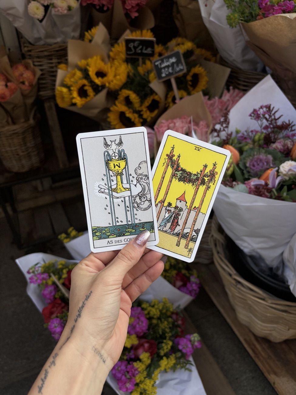 Tarot cards held at a flower market for a love reading